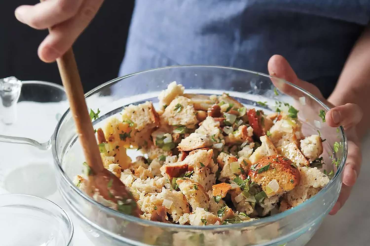 close up of someone mixing stuffing in a bowl