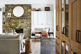 rustic modern living room with neutral tones and stone fireplace