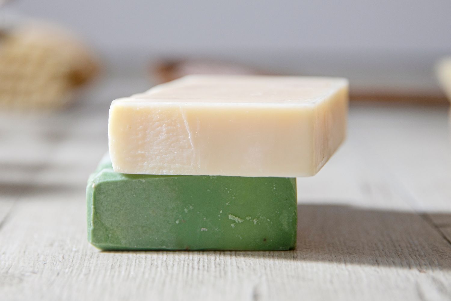 Stack of two bars of soap on a wooden surface