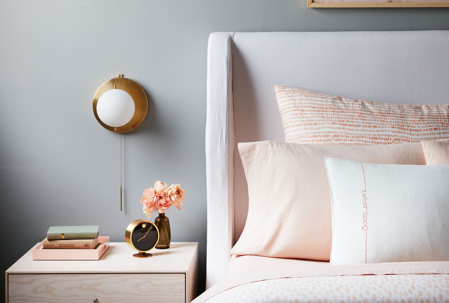 Bed with nightstand and wall sconce