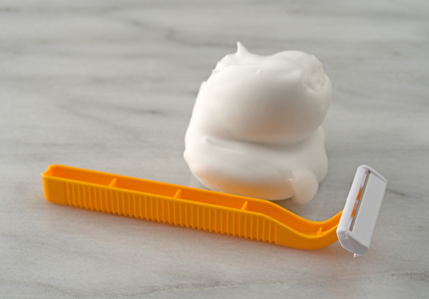 A razor and shaving cream on a surface