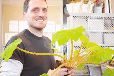 Ryan McCallister holding a begonia. 