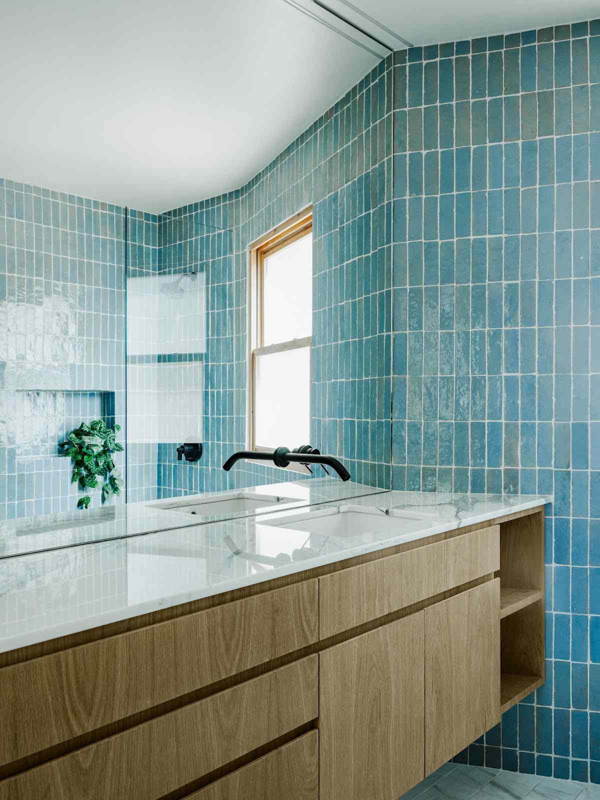 a bathroom with blue tile