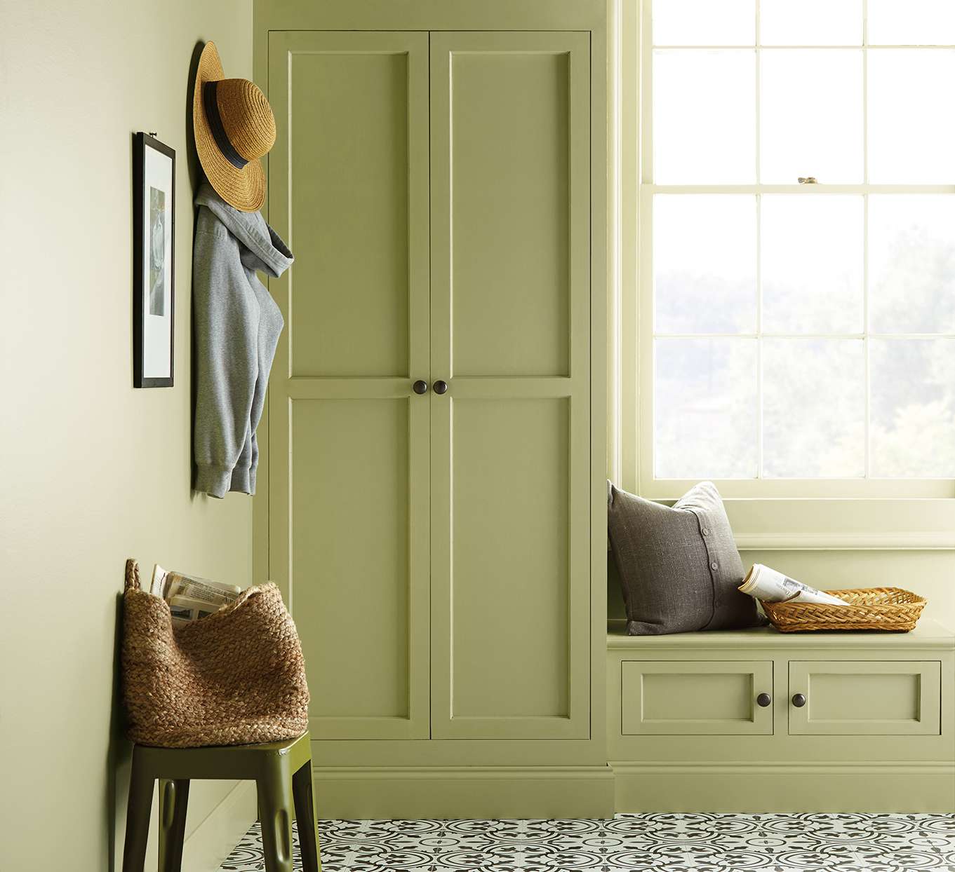 sage green cabinet and window seat with sun shining