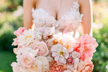 peony bouquets muted pink-and-white peonies, roses, and cosmos to mimic the fluffy dress bodice