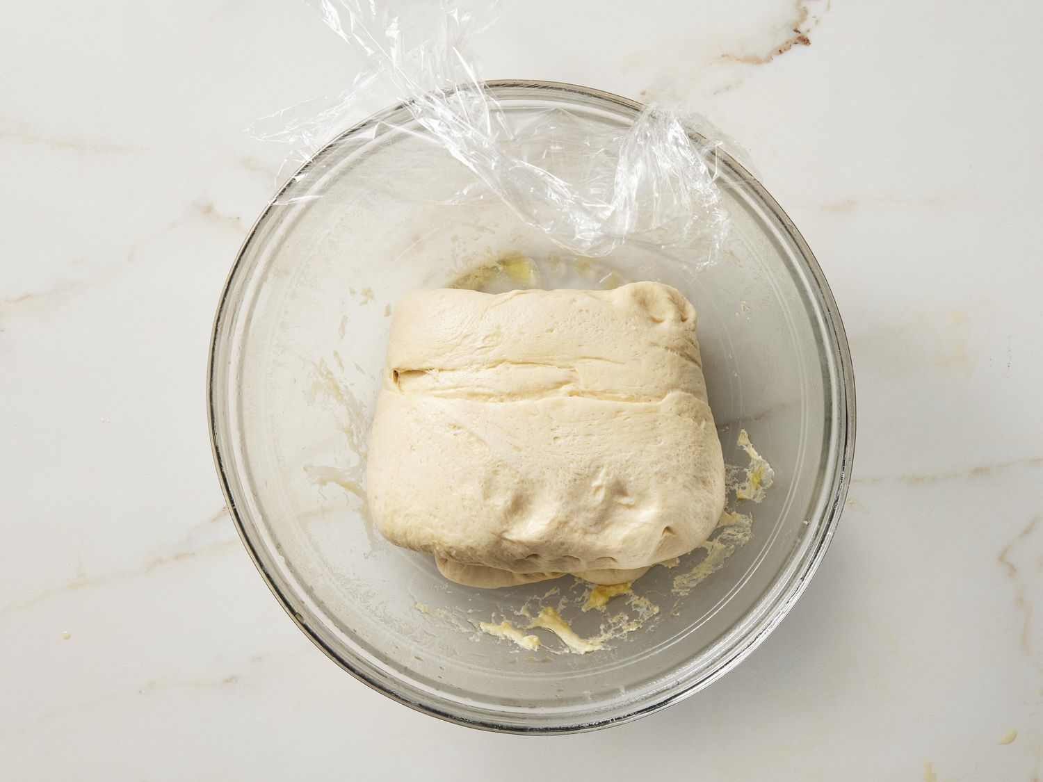 Folded dough in glass bowl