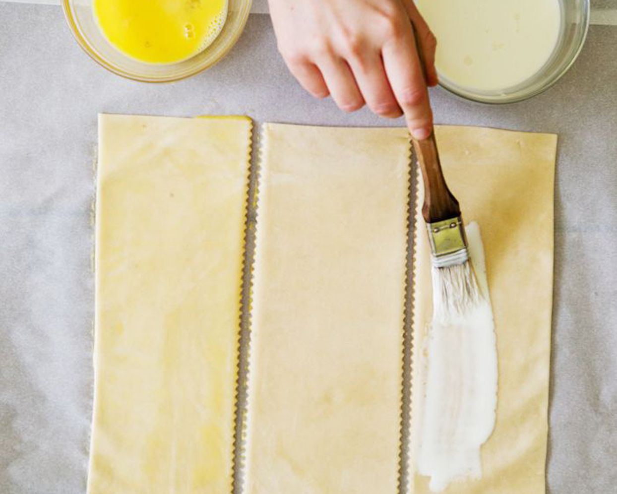 Applying cream to dough