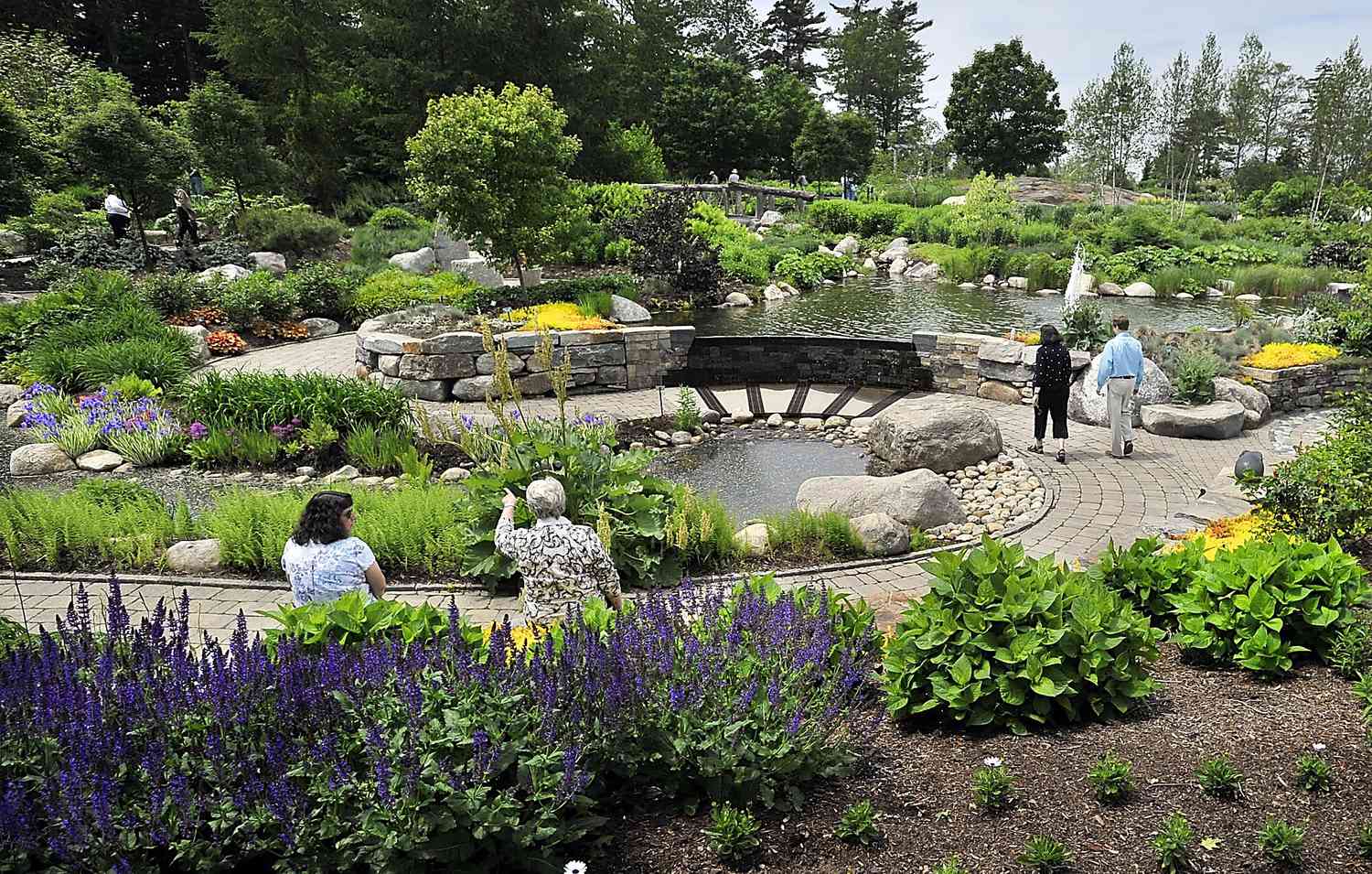 Visitors sit and walk in the Lerner Garden of the Five Senses