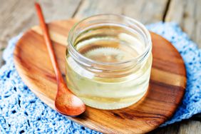 Corn syrup in glass jar on a wooden board