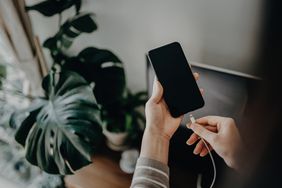 Woman charging smartphone