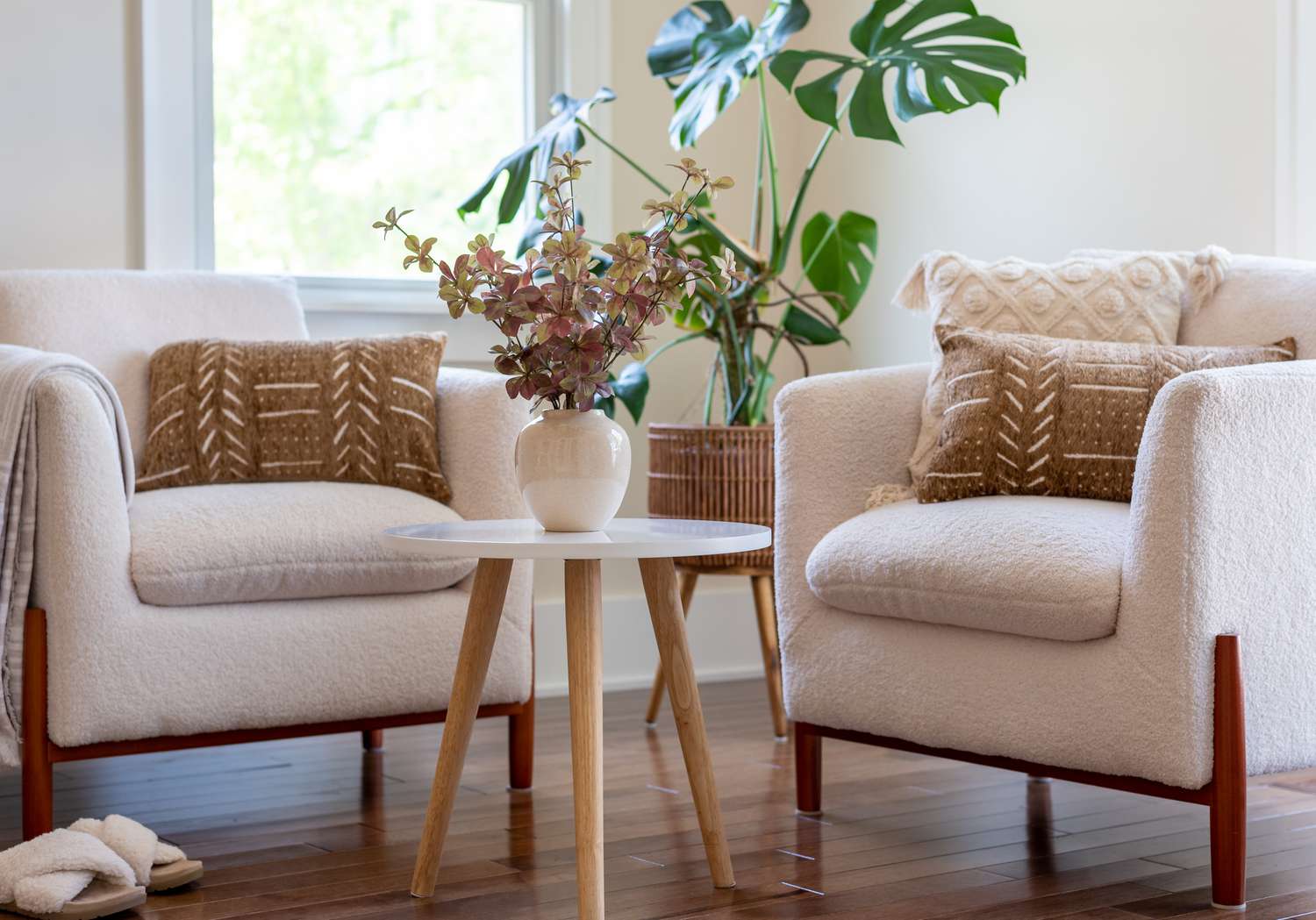 Cozy sunny corner in a stylish living room with neutral ivory and brown decor