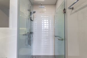 Modern shower stall with glass doors and a showerhead