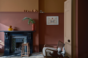 A tastefully decorated room featuring a fireplace a chair and a side table arranged stylishly