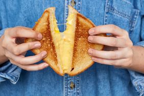 hands holding grilled cheese