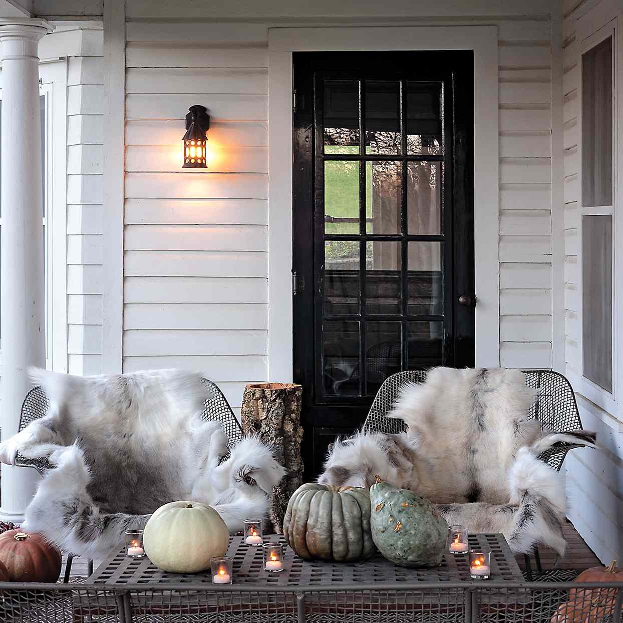fur throws on wire chairs on front porch