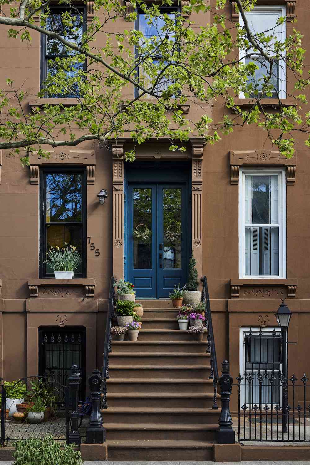 brown home with blue front door