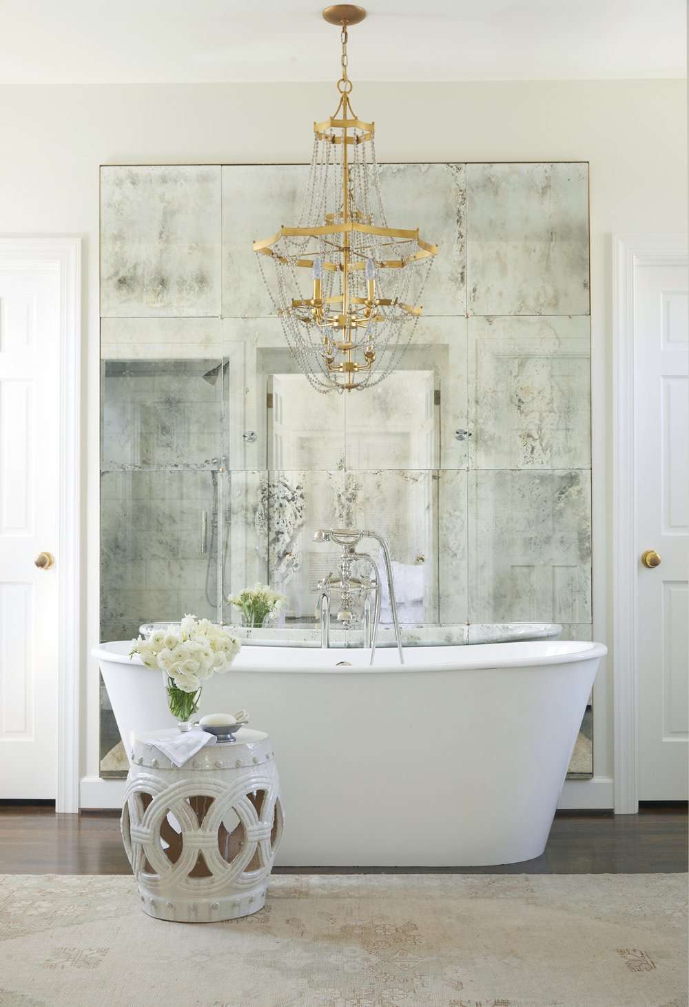 Luxury bathroom interior with a freestanding bathtub and chandelier
