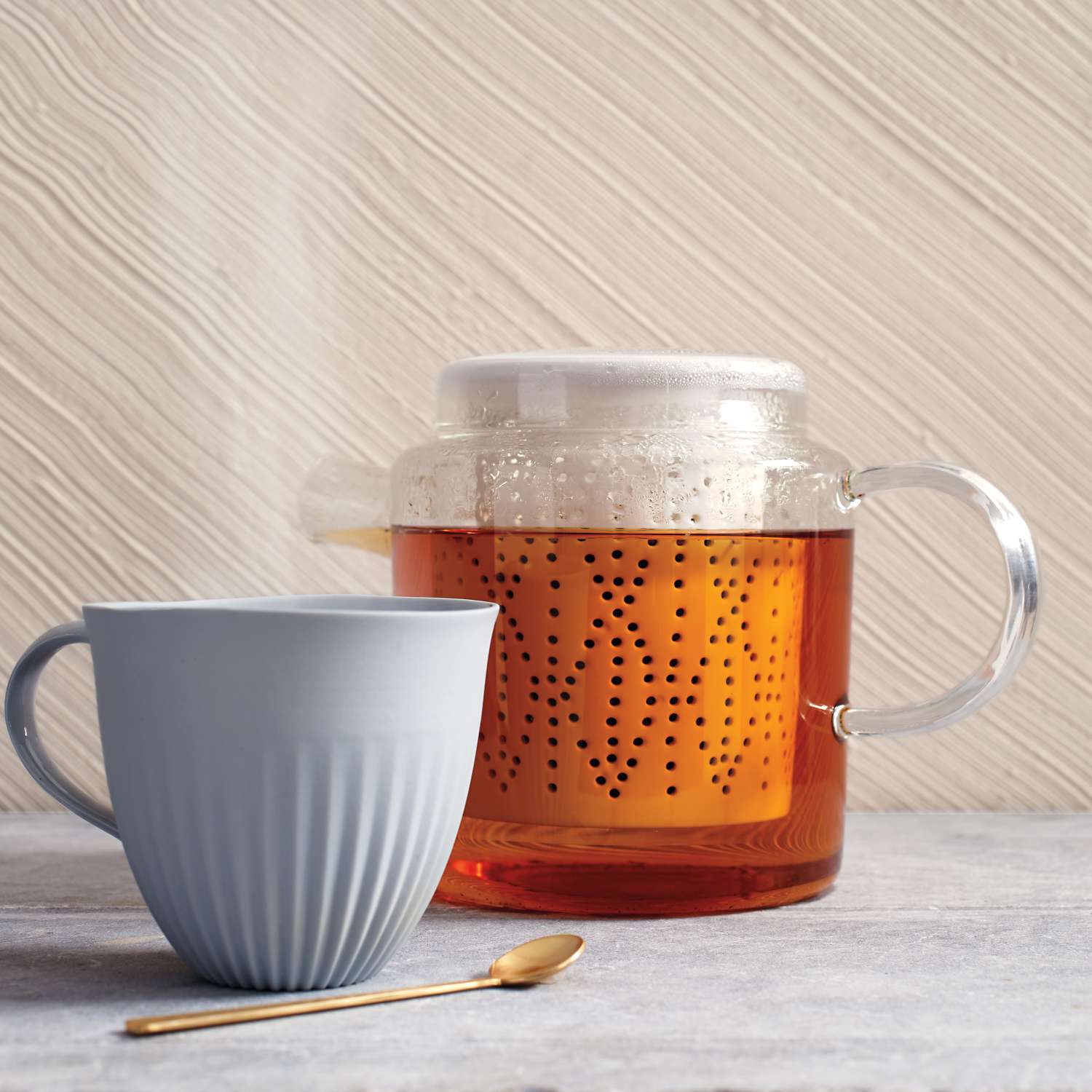 glass teapot with tea and ceramic mug