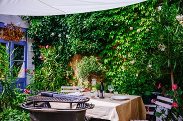 Barbeque cast iron grill and table ready for eating on terrace at home.