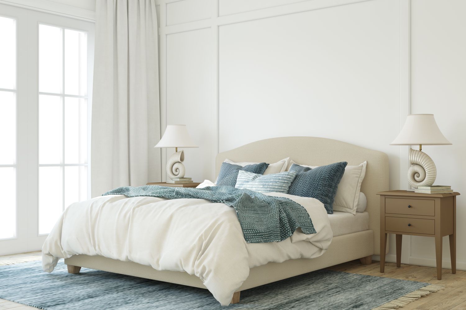 A neatly made bed with pillows two nightstands and decorative lamps in a brightly lit bedroom