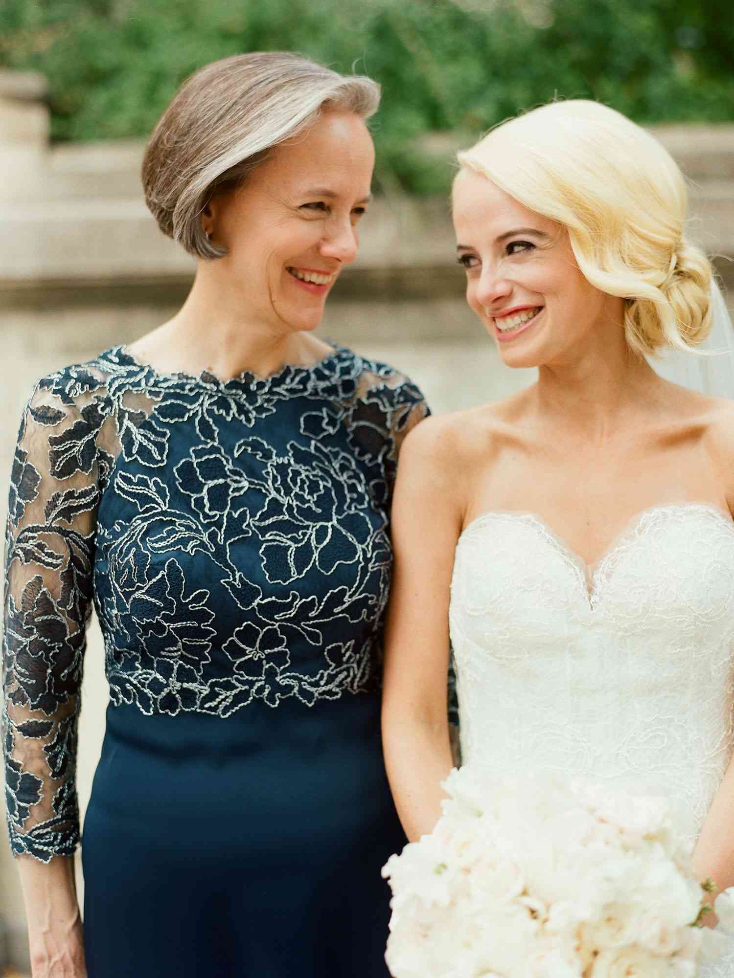 Bride in strapless wedding dress with the mother of the bride
