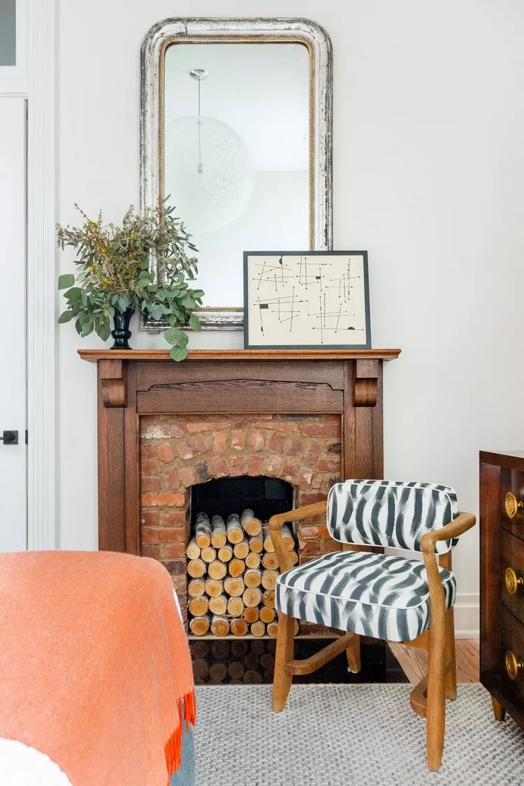 Faux Fireplace Frame With Greenery and Abtract Art