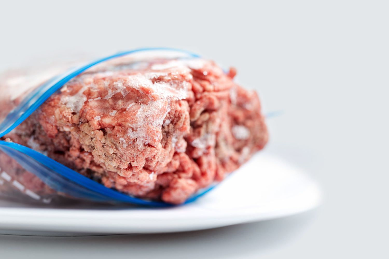 Frozen ground beef on plate