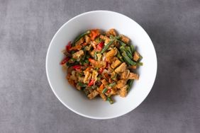 stir-fried tempeh and long beans in white bowl