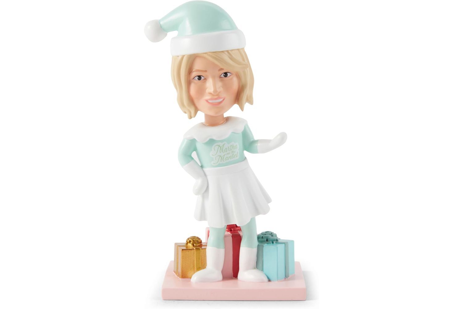 A bobblehead figure designed with a winter holiday theme featuring a woman in festive attire and surrounded by gift boxes
