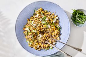 quinoa with caramelized corn and scallions served in a blue bowl