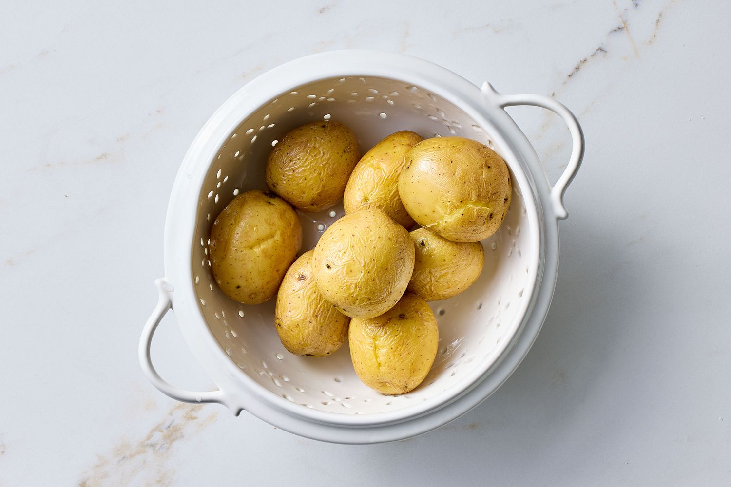Whole potatoes in a colander