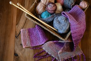 Accessories for knitting in basket ( yarn, needles) and scarf