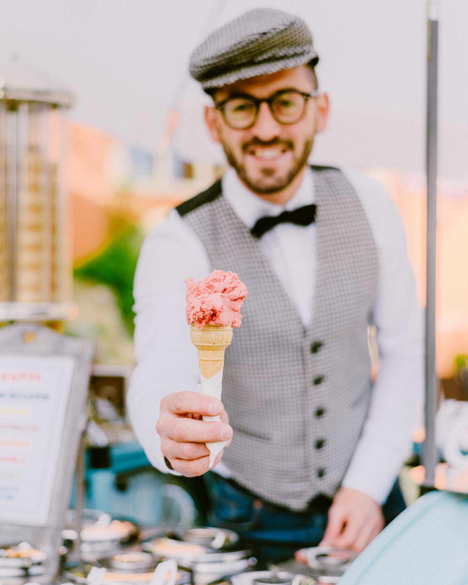 man serving pink ice cream cone