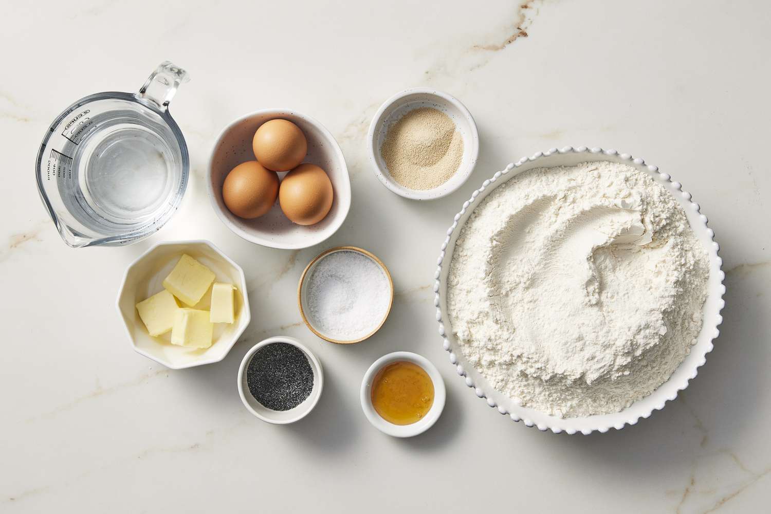 Ingredients to make kaiser rolls, butter, eggs, salt, flour
