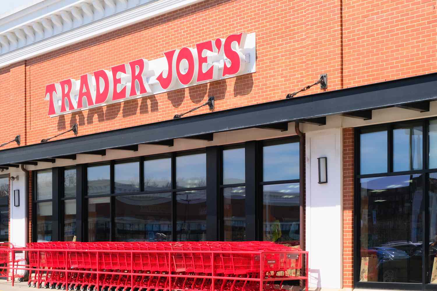 Entrance of a Trader Joes store with shopping carts lined up outside