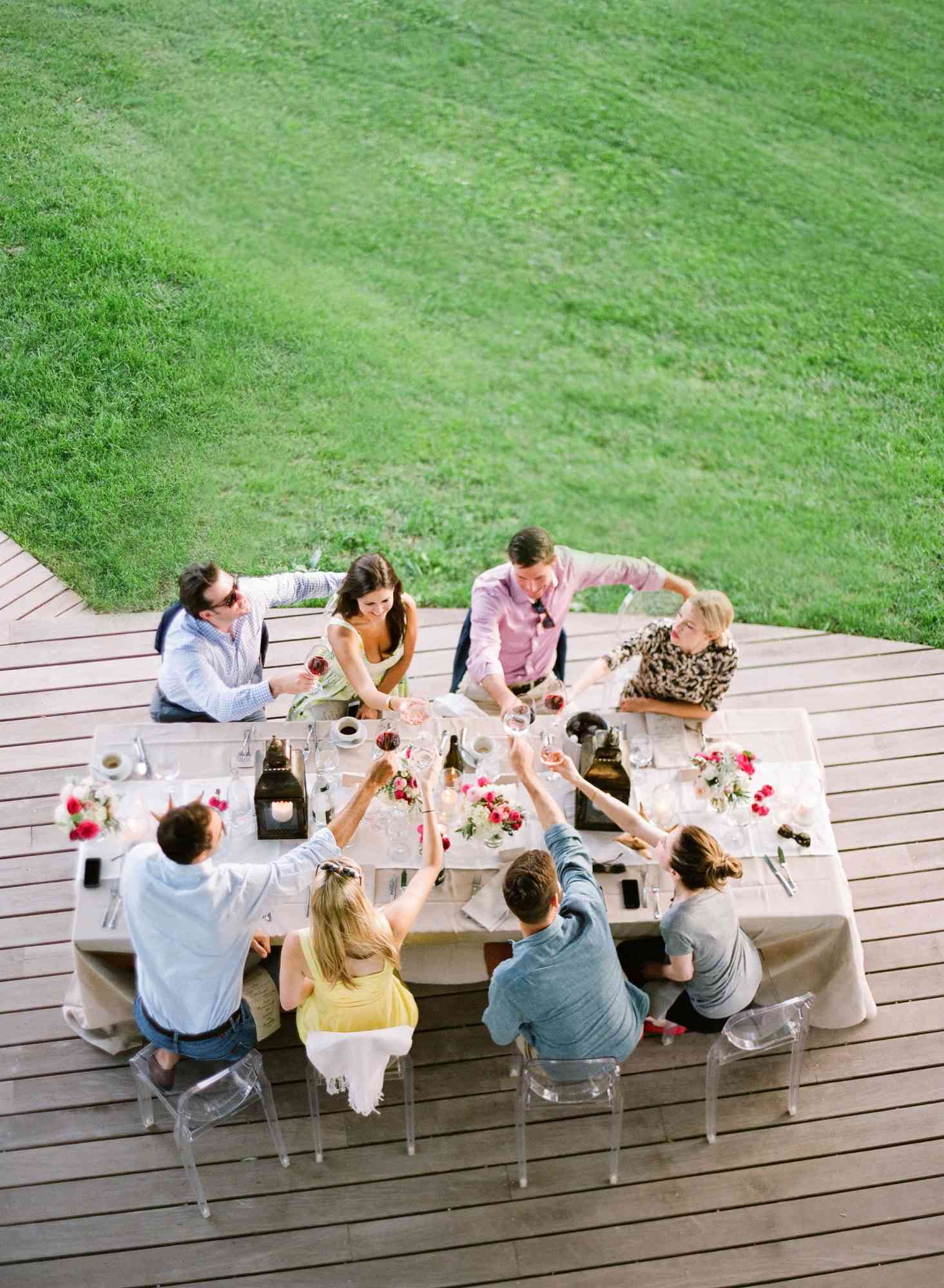 engagement party people sitting around table drinks cheers