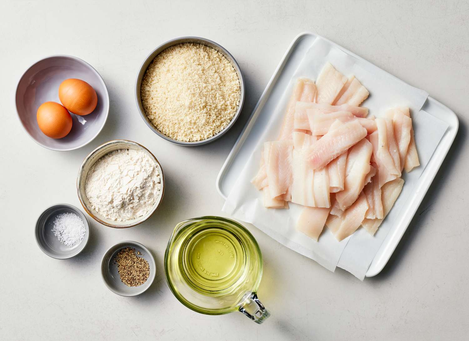 ingredients for breaded fish, eggs, panko, flour, oil 