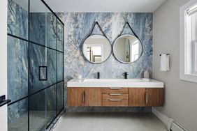 blue stone bathroom with circle mirrors 