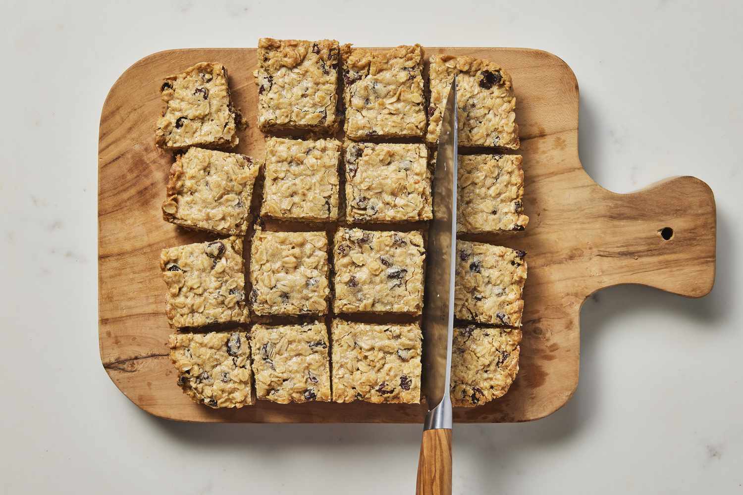 Cut oatmeal rasin bars on cutting board