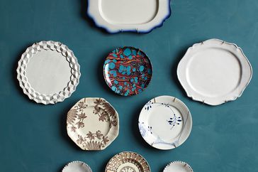 plates hung on teal wall