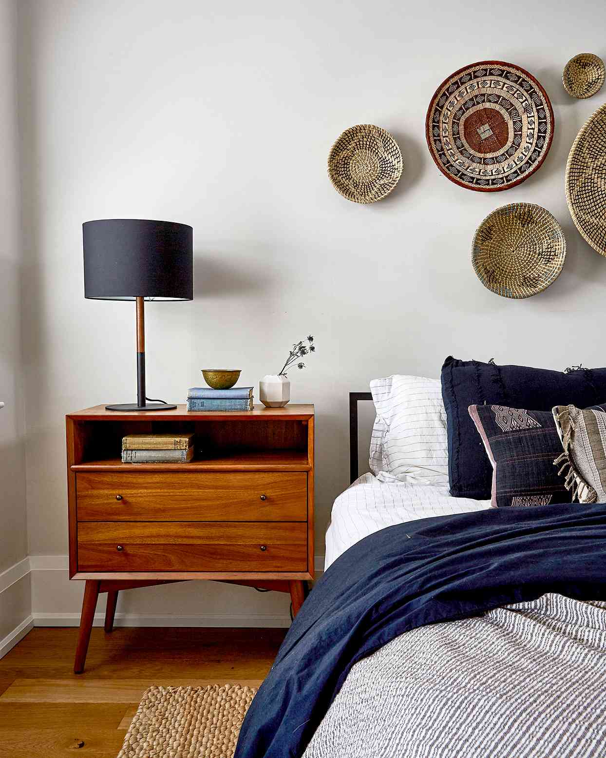 Bedroom with woven basket decoration above bed