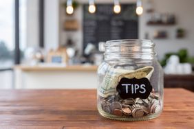Tip jar with money in it 