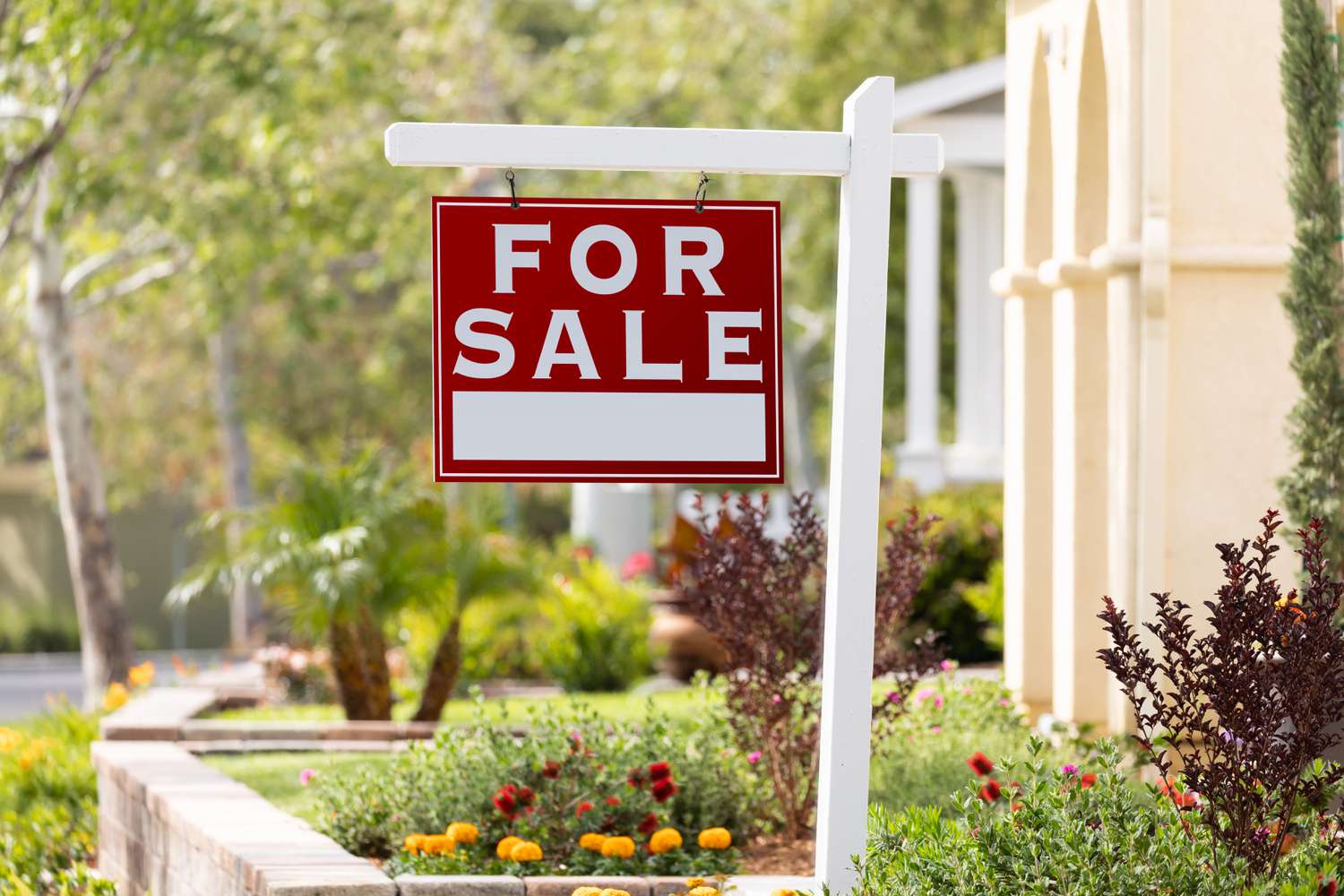 red for sale sign in front of house