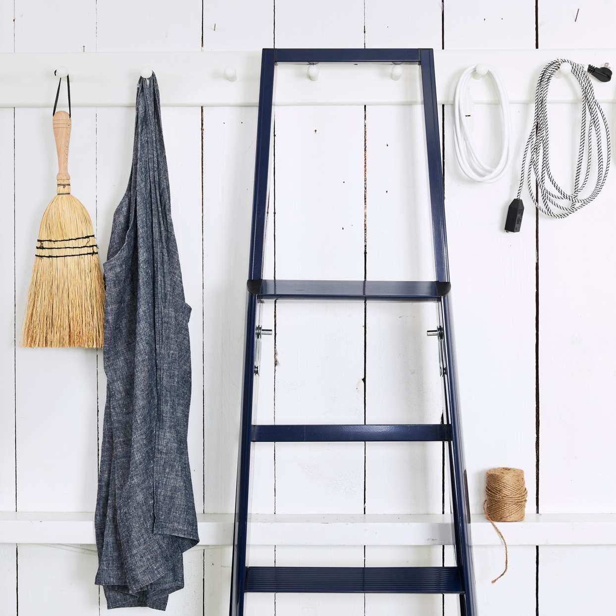 supply closet black ladder and duster