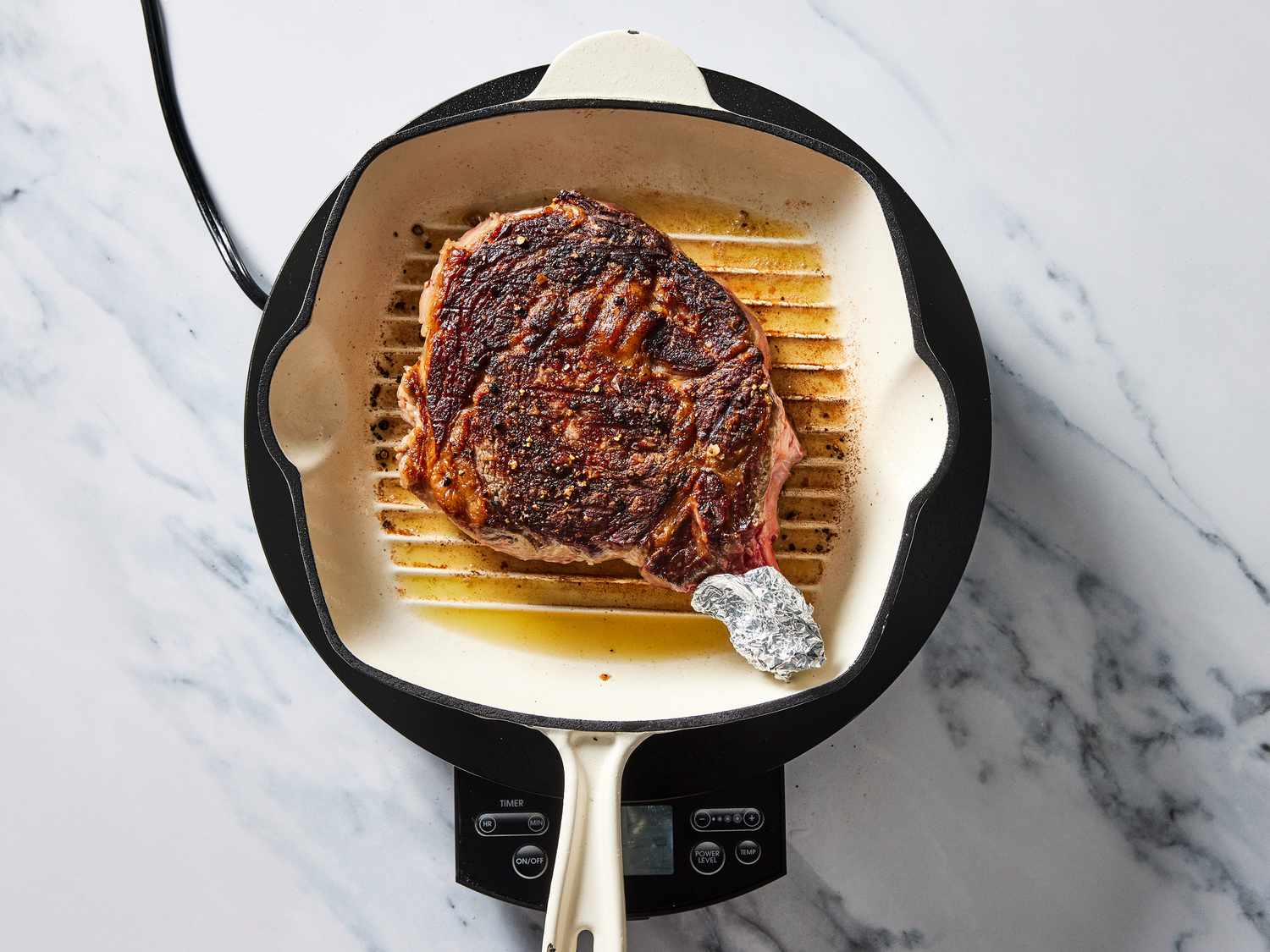 Steak grilling on skillet
