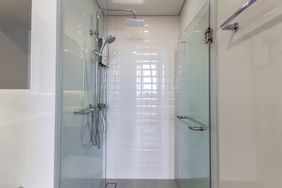 Modern shower stall with glass doors and a showerhead