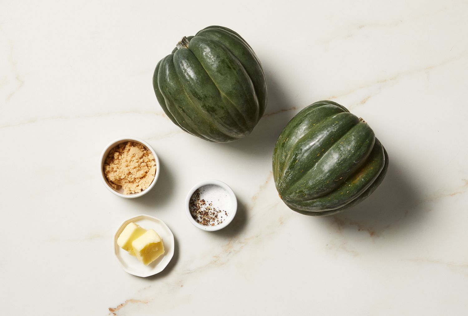 overhead view of ingredients and acorn squash on marble