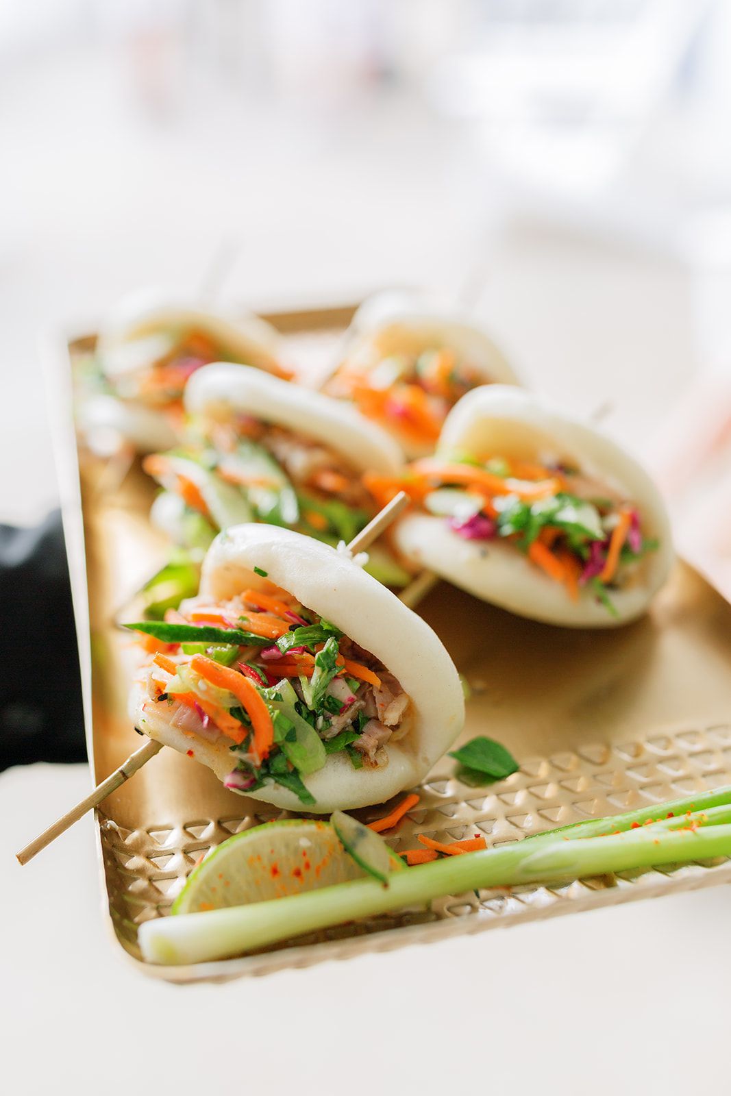 wedding cocktail hour food on skewers served on gold tray