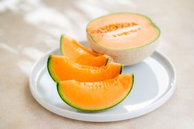 Slices of cantaloupe melon on a white plate