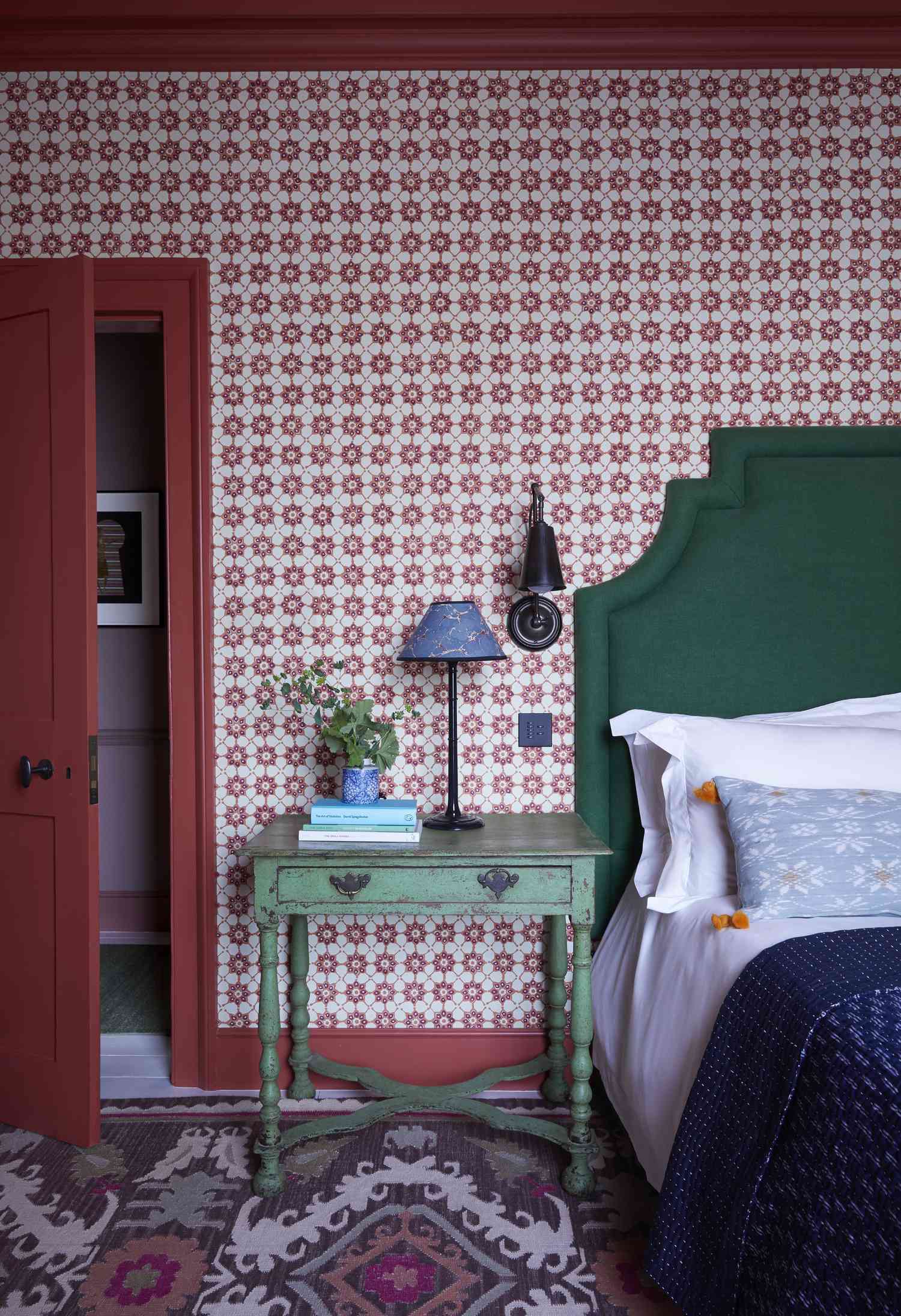 red wallpaper and green headboard